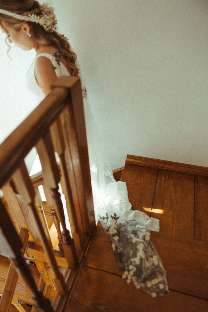 Details of bride's veil while walking downstairs