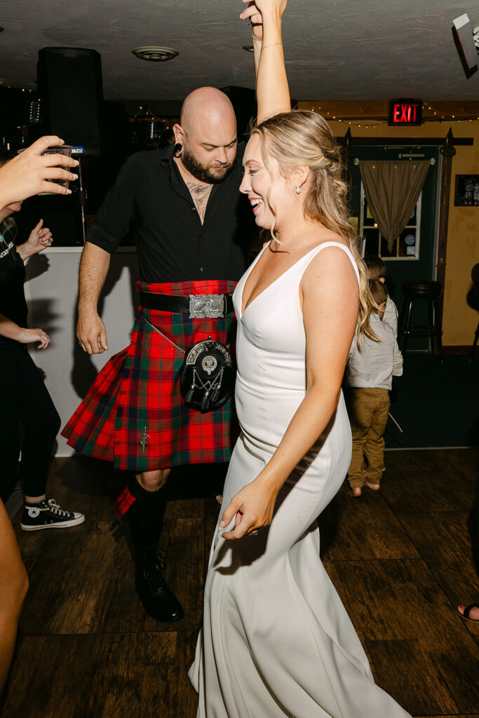 Bride and groom dancing together during their wedding reception 
