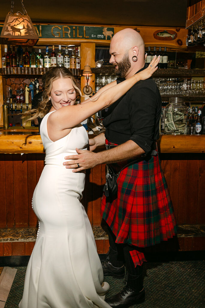 Bride and groom dancing together during reception 