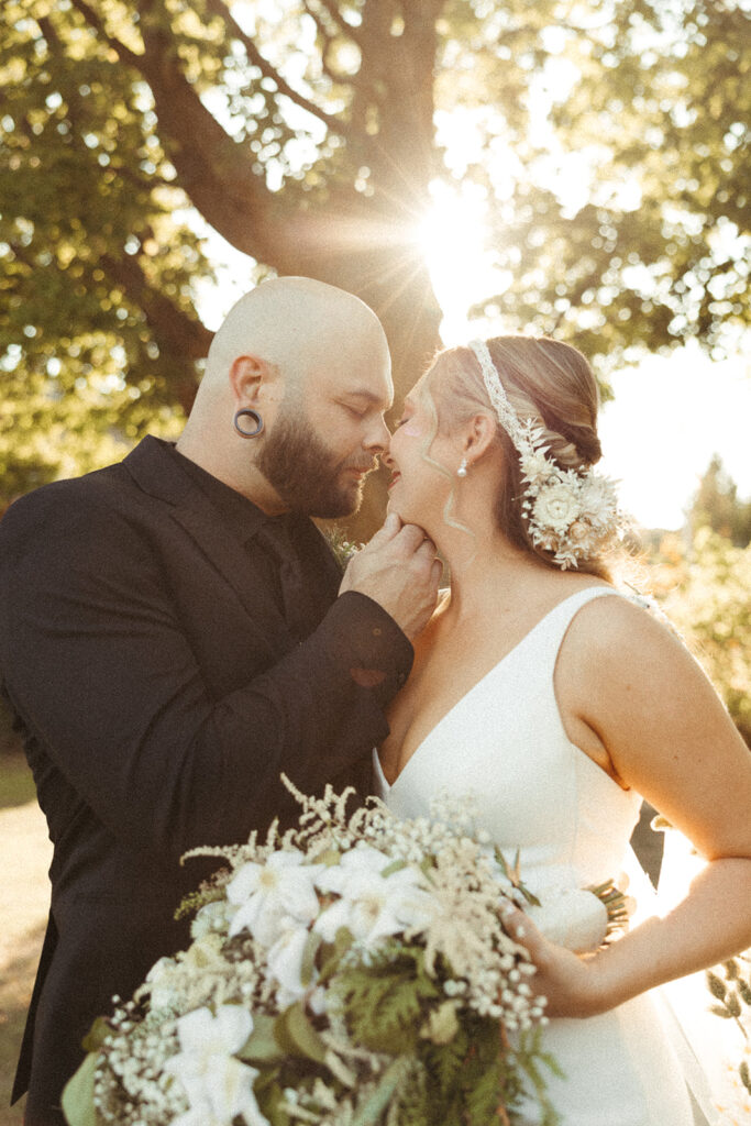 Bride and Groom sharing a kiss during outdoor portraits after their Door County wedding