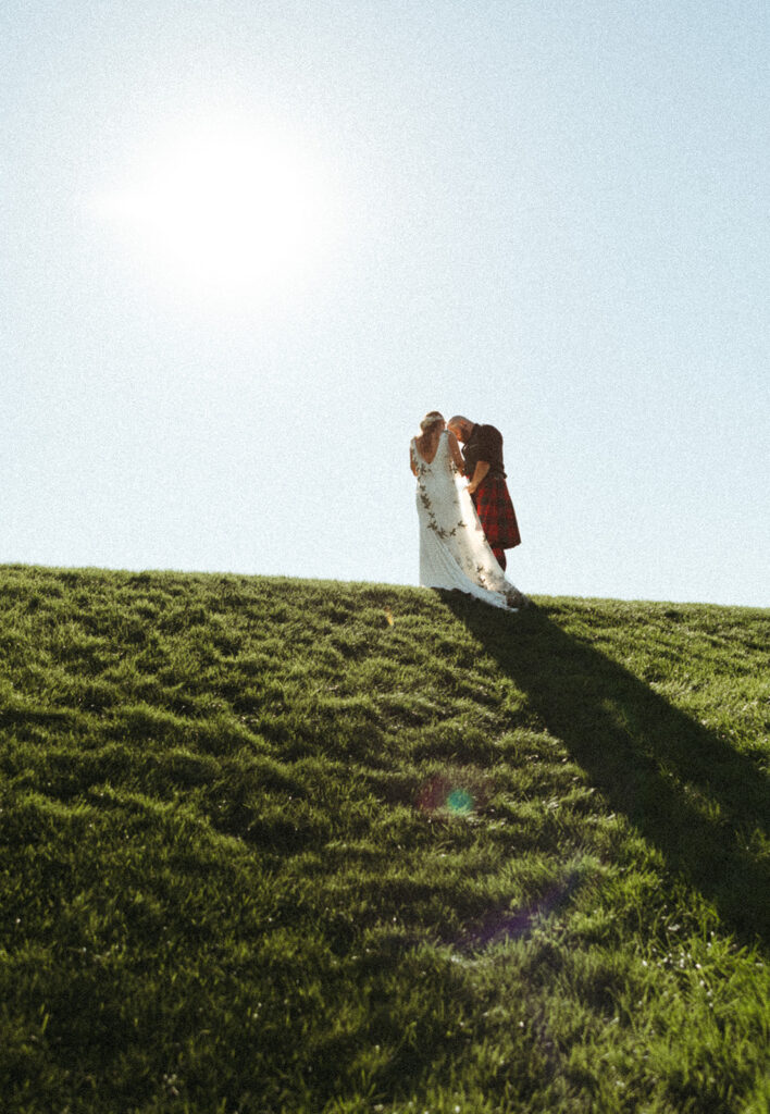 Bride and groom standing on roof of Al Johnson's roof in Sister Bay, Door County