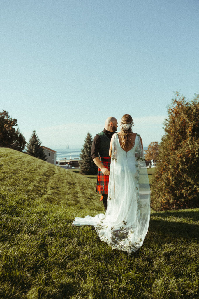 Bride and groom facing each other on roof of Al Johnsons in Sister Bay, Wisconsin 