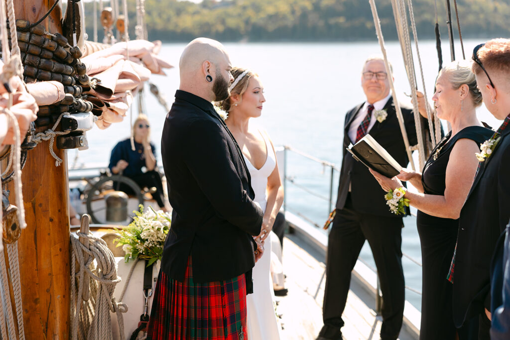 Couple standing together during their sailboat wedding ceremony in Door County, Wisconsin