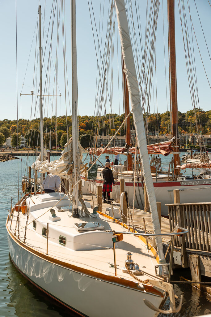 Groom waiting by the sailboats for his bride to show up for their Door County sailboat wedding 
