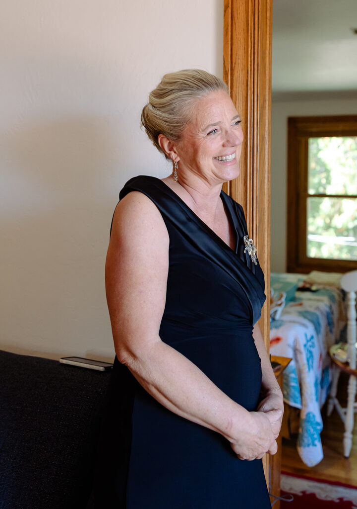 Mother of Bride looking at Bride as she sees her in her dress for the first time