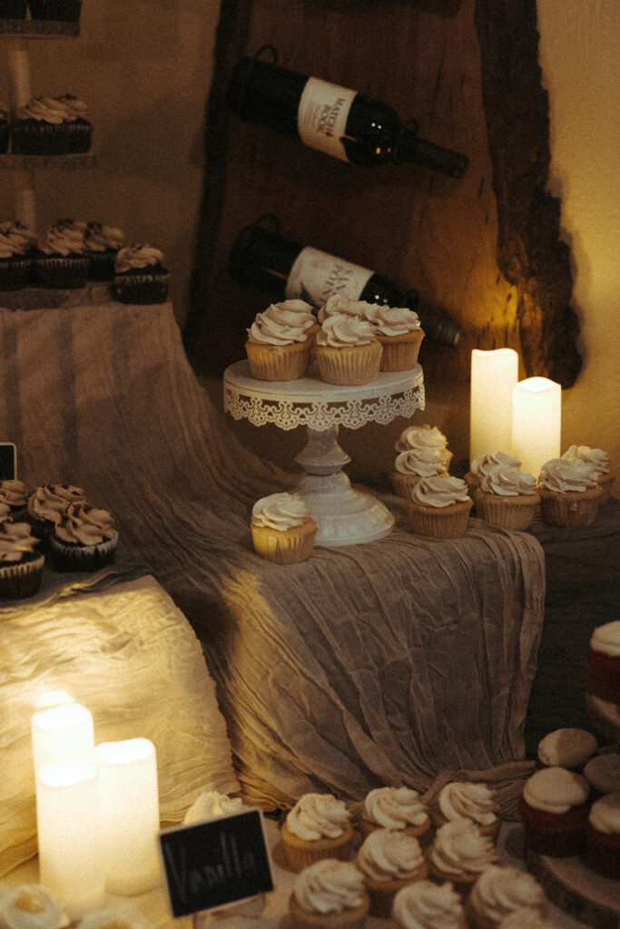 Wedding dessert table with cakes and candles at a Door County wedding reception 