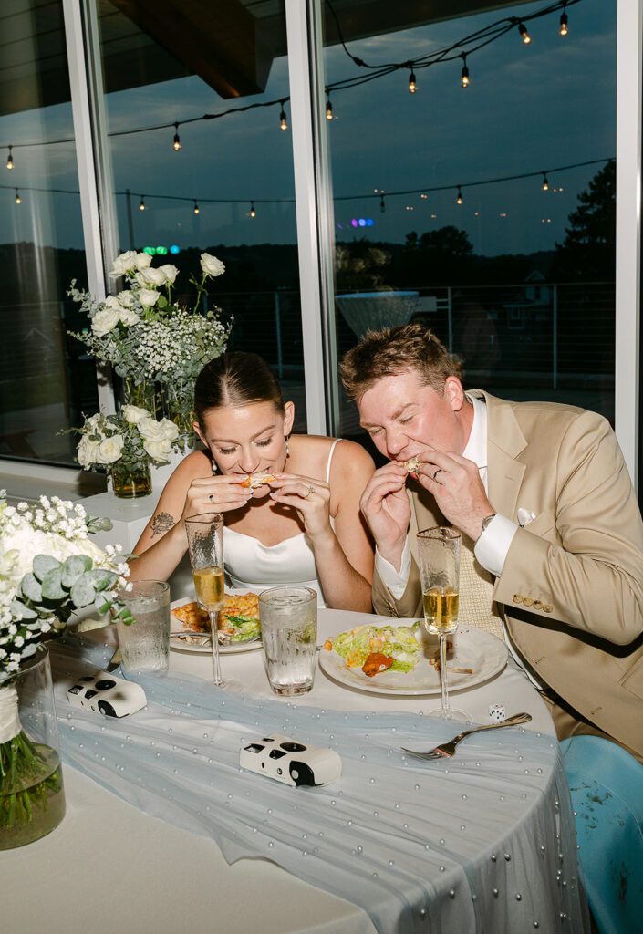 Bride and groom eating dinner together during their Door County wedding reception