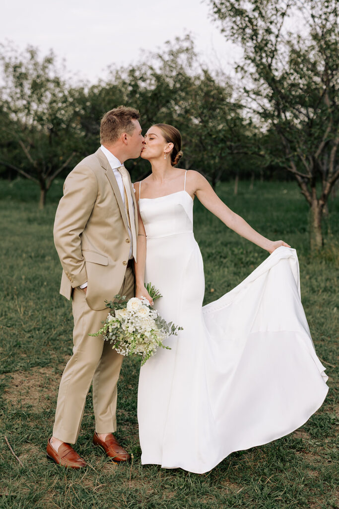 Bride and groom standing together during Door County wedding portraits