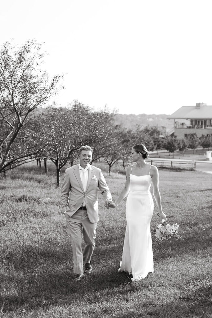 Bride and Groom walking together in a candid black and white moment during their Door County wedding