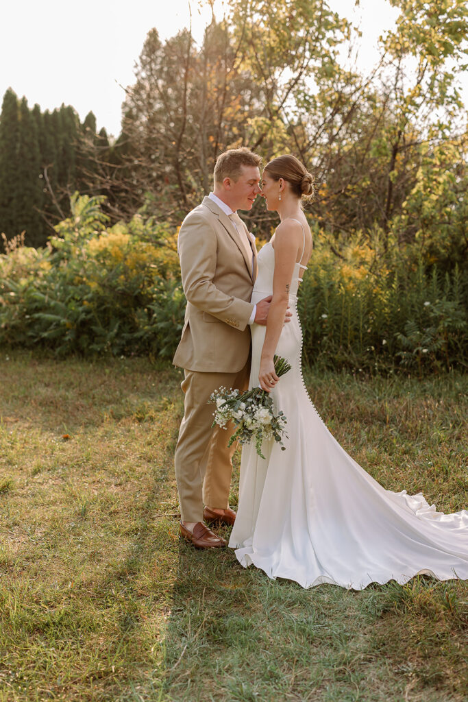 Bride and groom sharing a quiet moment during a golden hour on their Door County wedding day