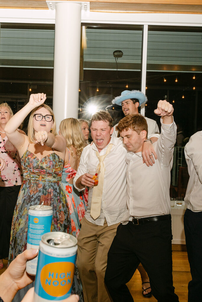 Wedding guests dancing and celebrating during a fun Door county wedding reception