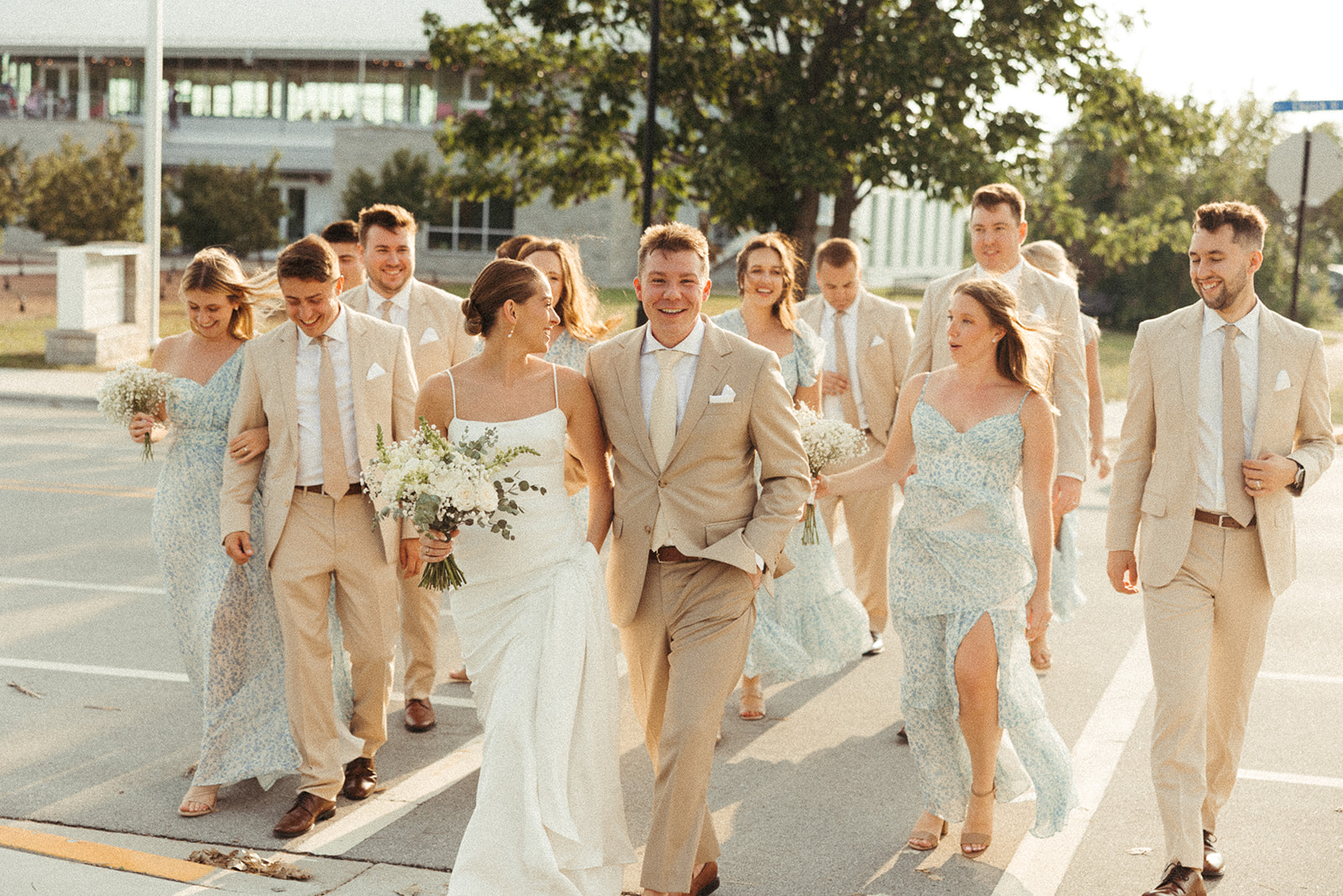 Bride and groom walking alongside wedding party during a Door County wedding celebration