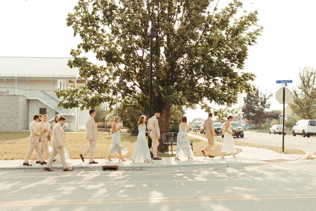Wedding party walking together in front of the Kress Pavilion before a wedding