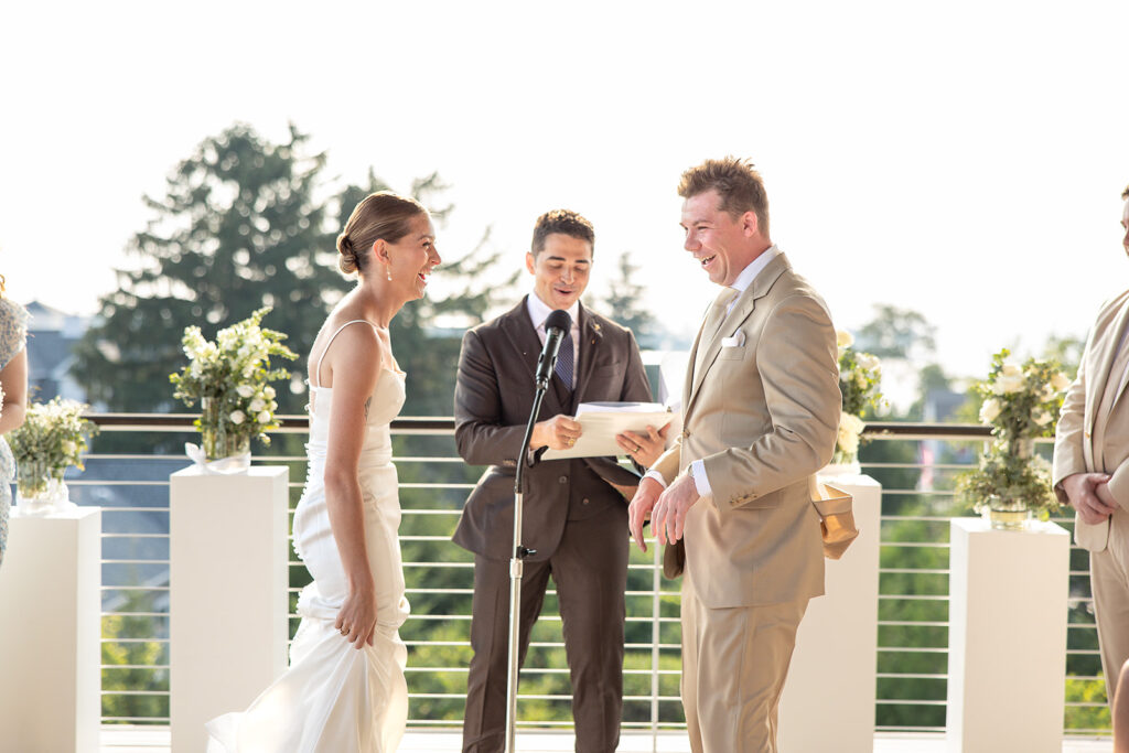 Bride and groom exchanging rings during their Door County wedding ceremony