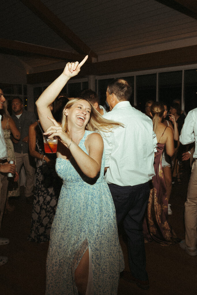 Wedding guests dancing and celebrating during a fun Door county wedding reception