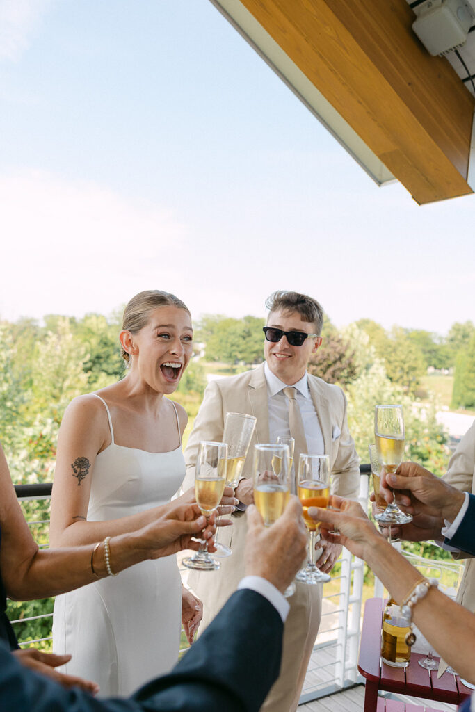 Bride and groom celebrating with friends and family during cocktail hour at a Door County wedding