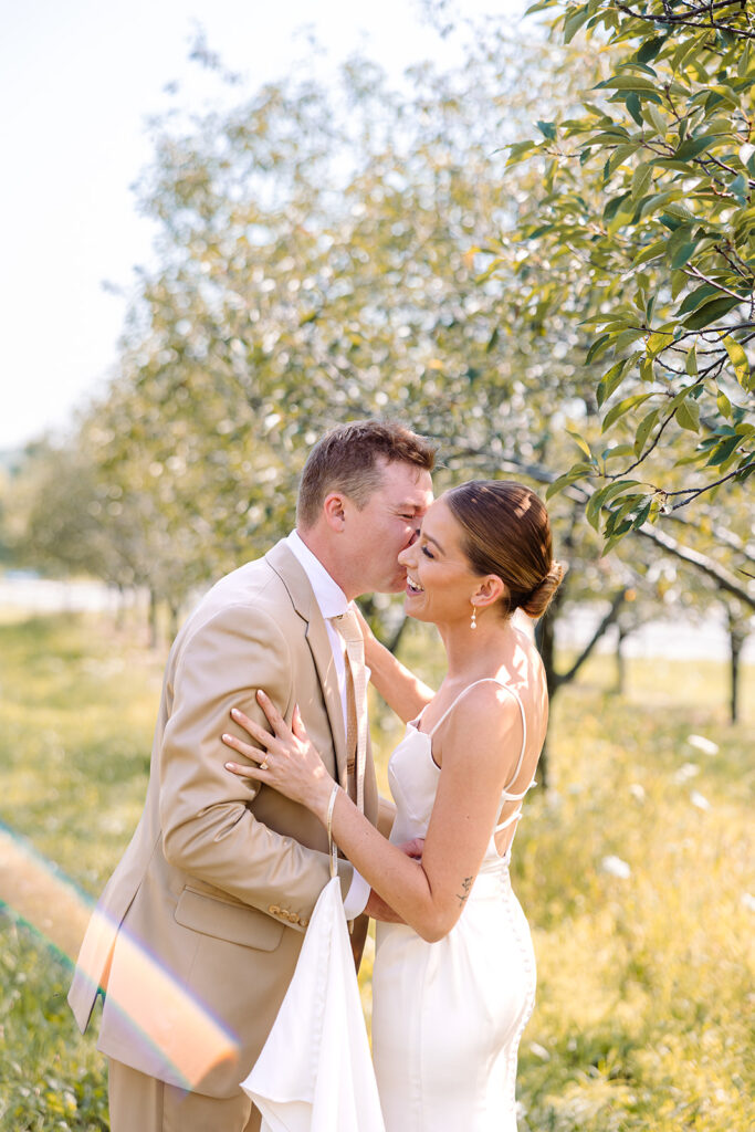 Bride sneaking up on groom for their first look at Kress Pavilion