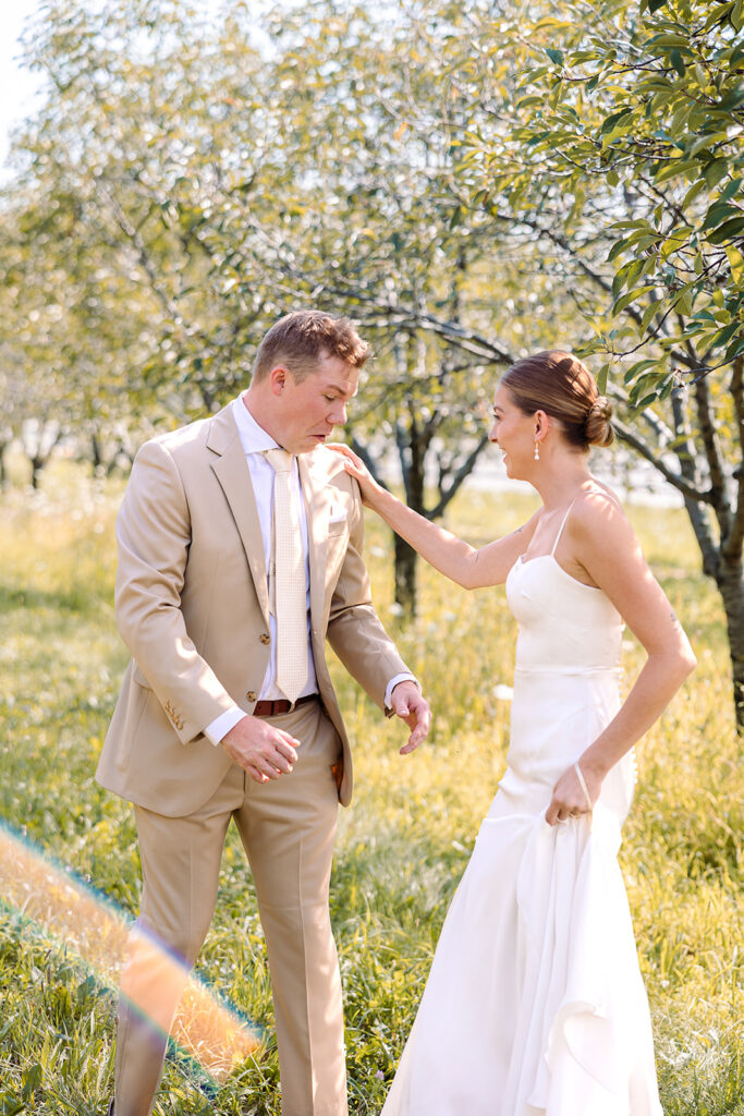 Bride sneaking up on groom for their first look at Kress Pavilion