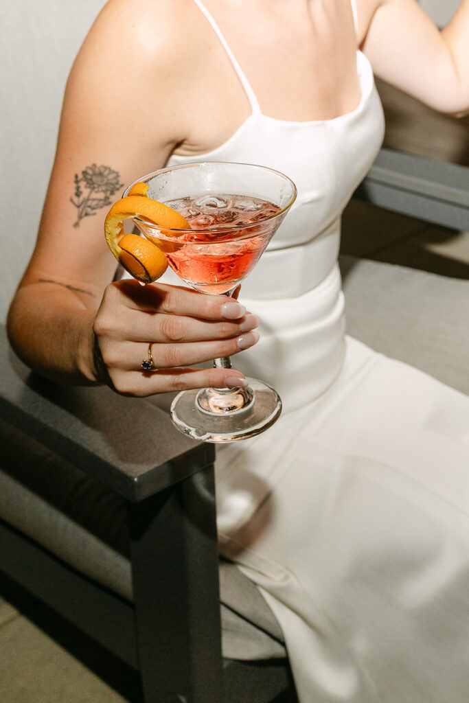 Bride holding a cocktail during a relaxed Door County wedding reception