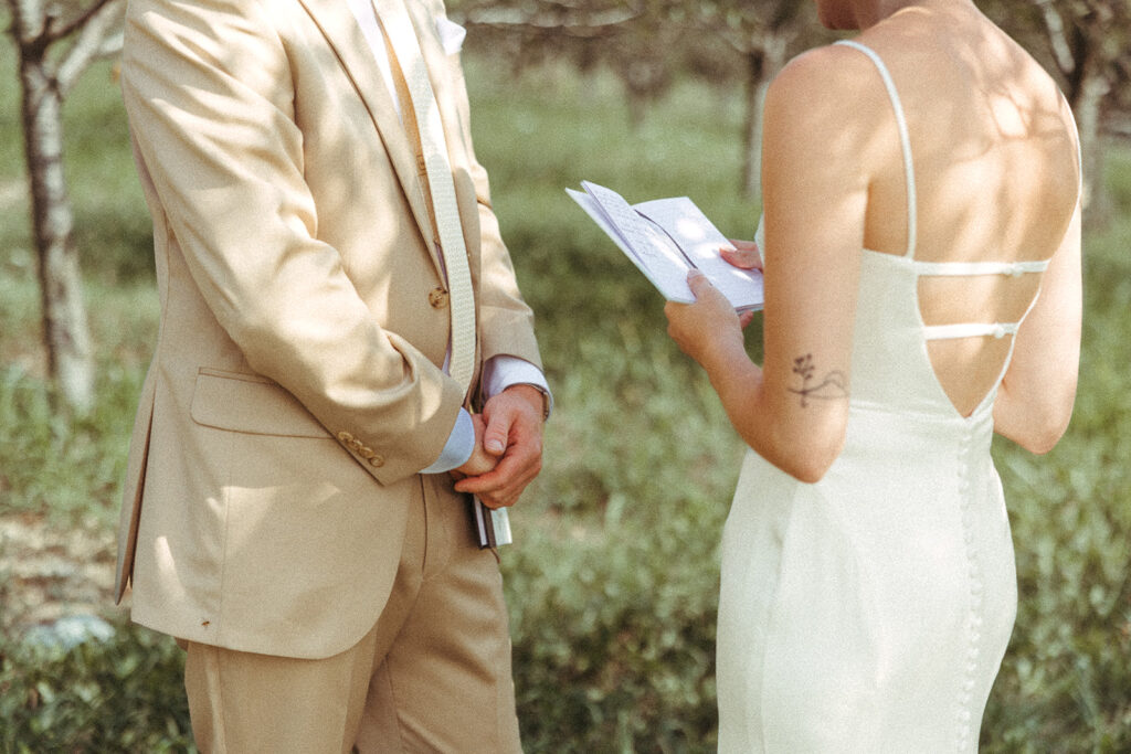 Bride and groom holding vow book during a Door County wedding