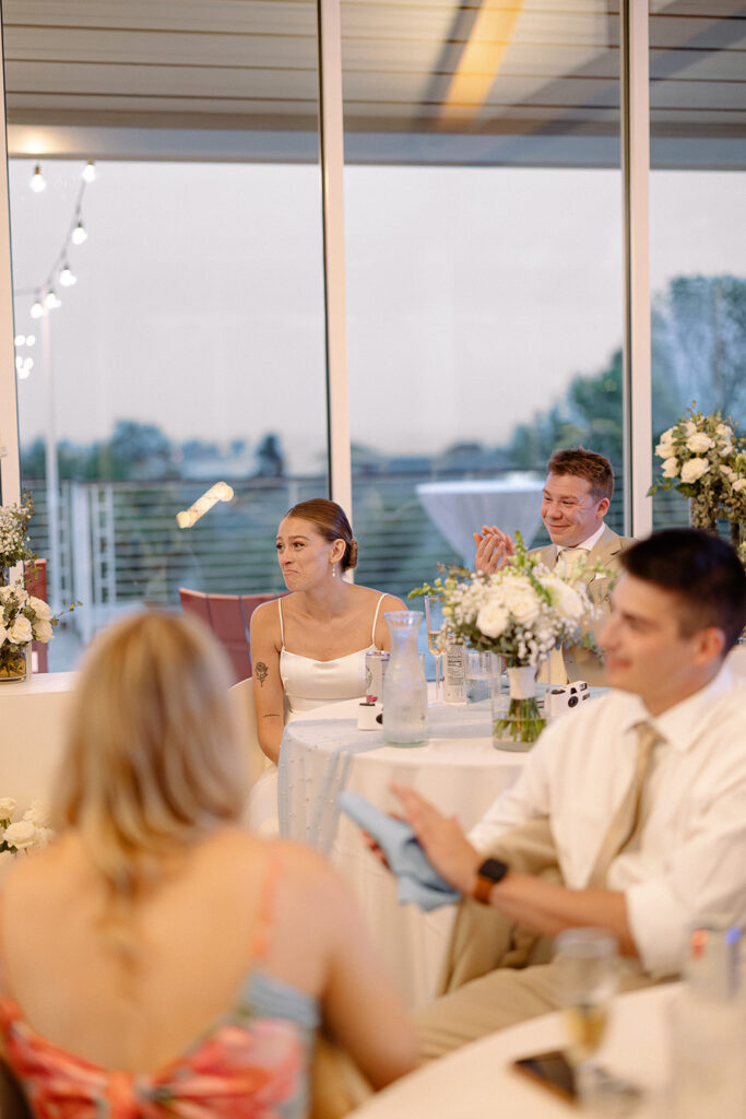 Bride and groom laughing together during a Door County wedding reception