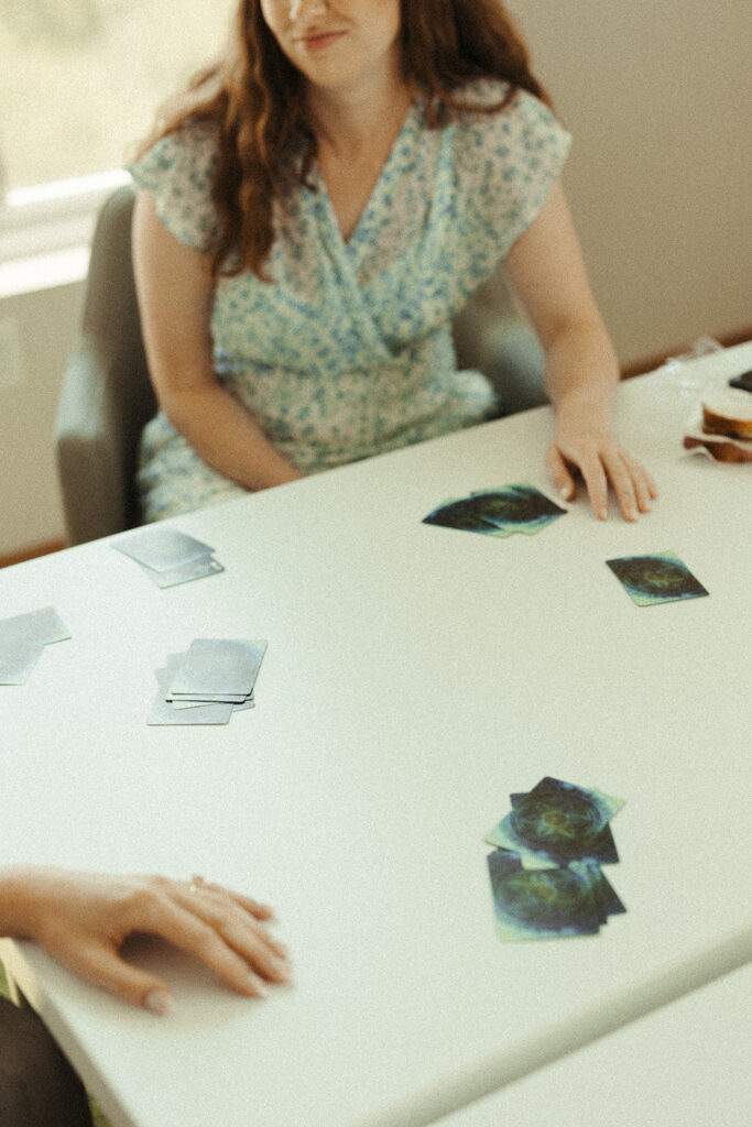 Bridesmaids playing cards and. hanging out while getting ready for a Door County wedding