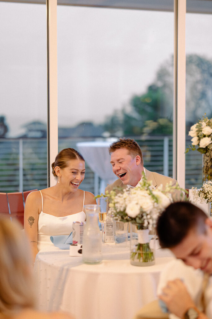 Bride and groom laughing together during a Door County wedding reception
