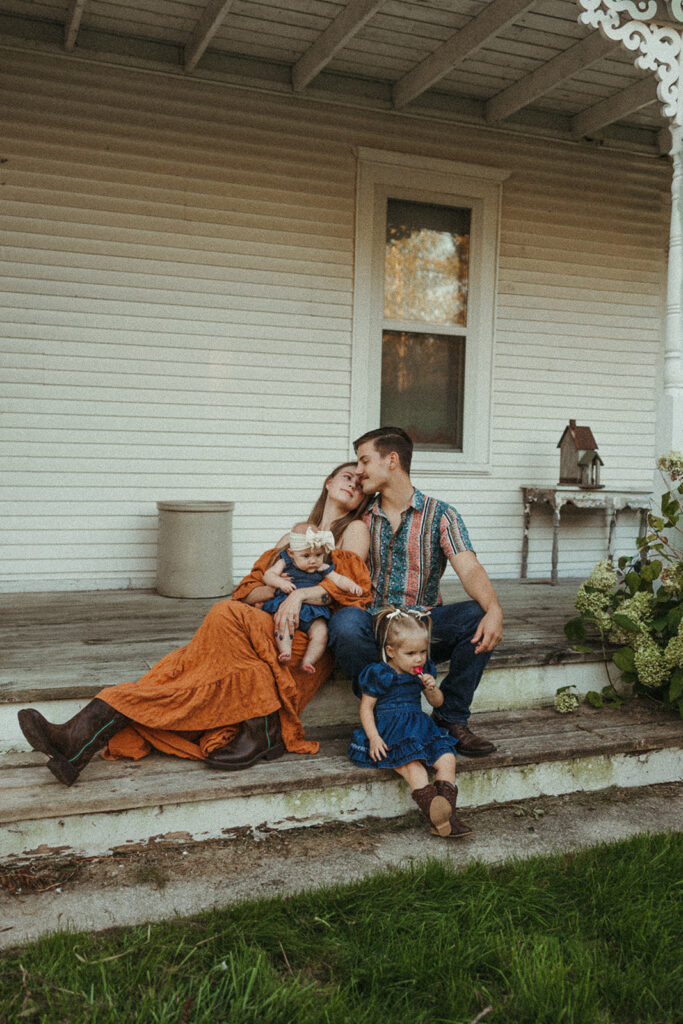 Parents and children interacting naturally during a fall family session on a Door County farm.