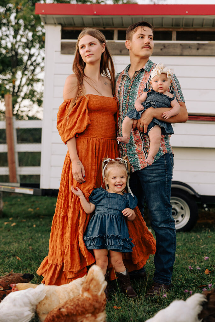 Child laughing while exploring a farm during a relaxed fall family session in Door County, Wisconsin.