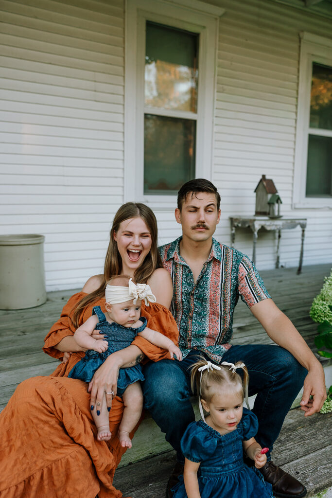 Parents and children interacting naturally during a fall family session on a Door County farm.